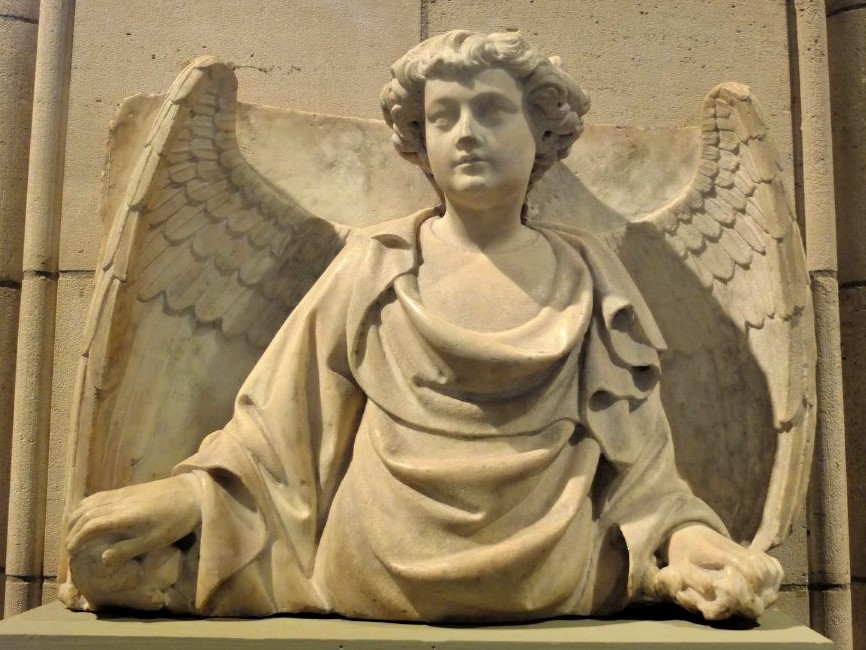 a Medieval stone sculpture of an angel