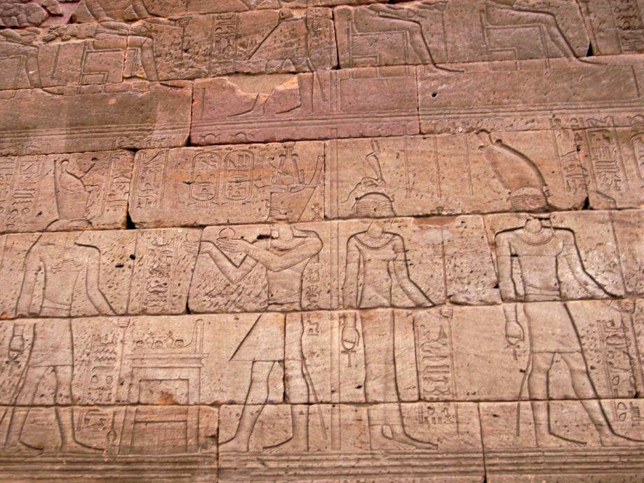 a stone panel covered in ancient Egyptian heiroglyphics