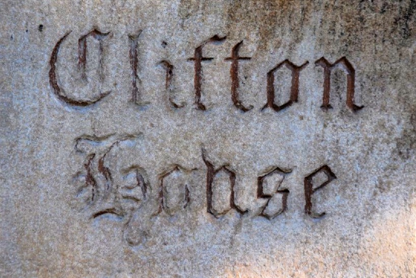 a close-up photo of a stone with carved letters that read Clifton House