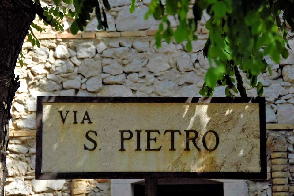 A rectangular street sign that reads via S. Pietro