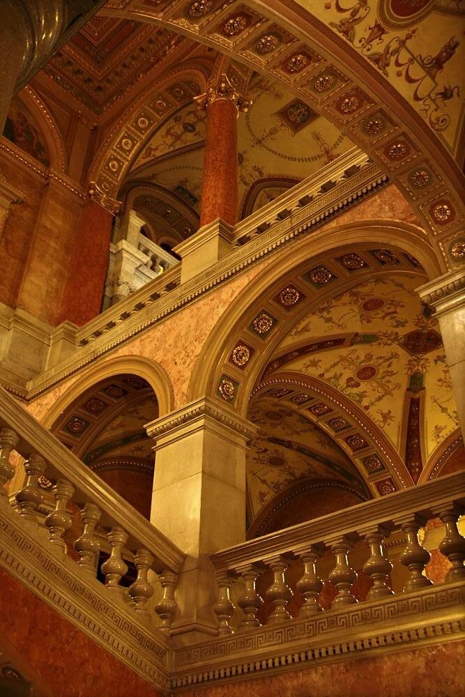 An opulent multilevel hall of archways and intricately decorated ceilings