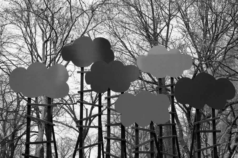 An outdoor metal sculpture depicting floating clouds