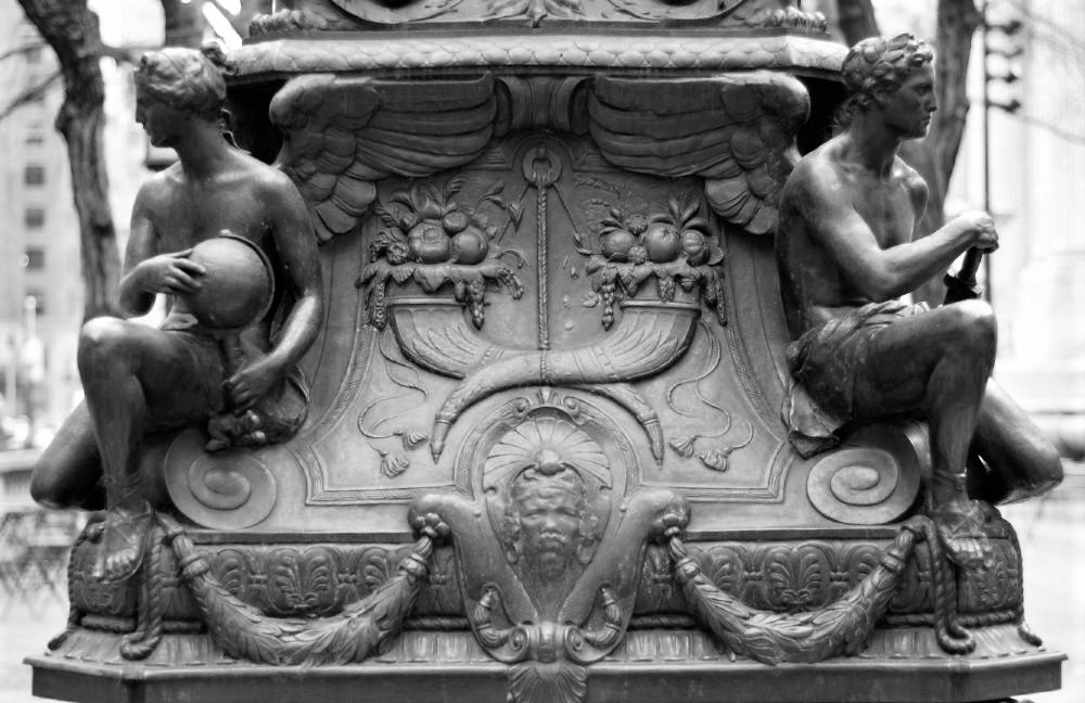 The ornate base of a metal lamppost