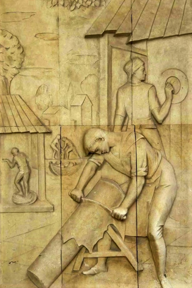 A sandstone frieze depicting artisans curing leather