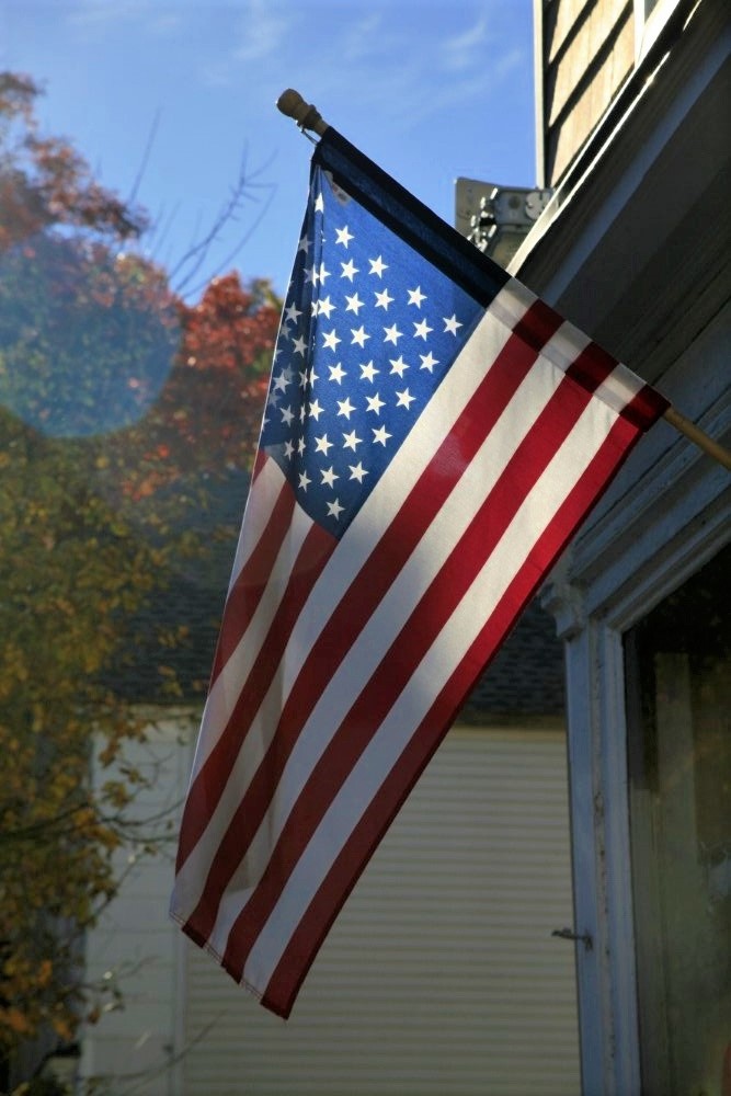 An American flag hanging outside a residential home