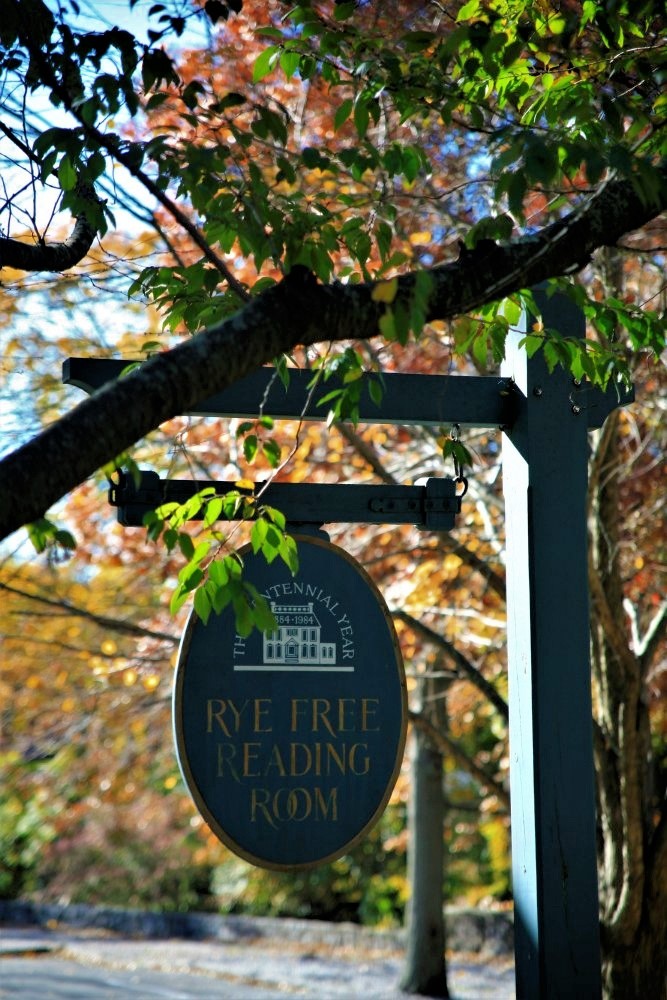 A wooden sign advertising the Rye Free Reading Room