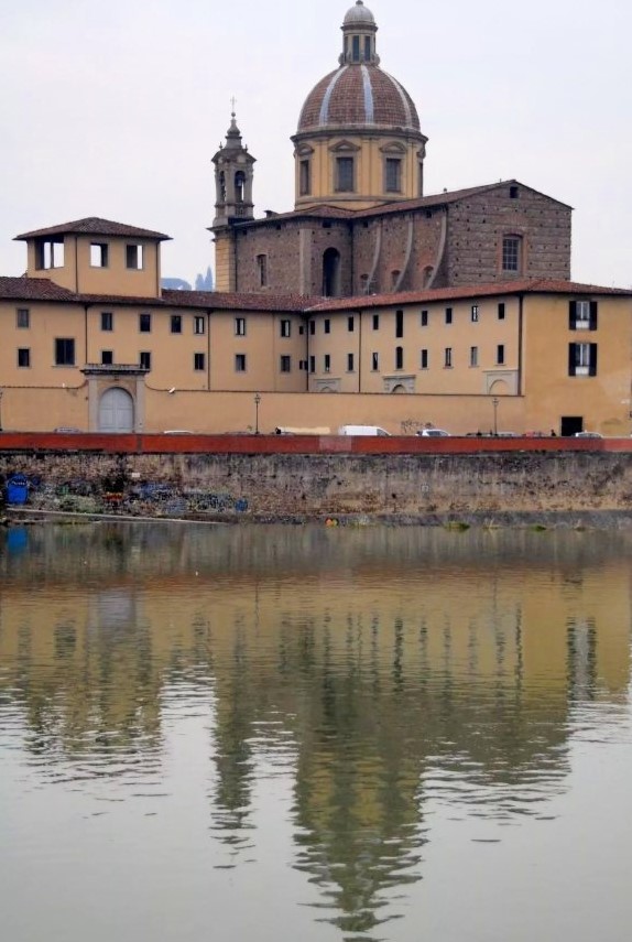 A cathedral reflected in water in the foreground