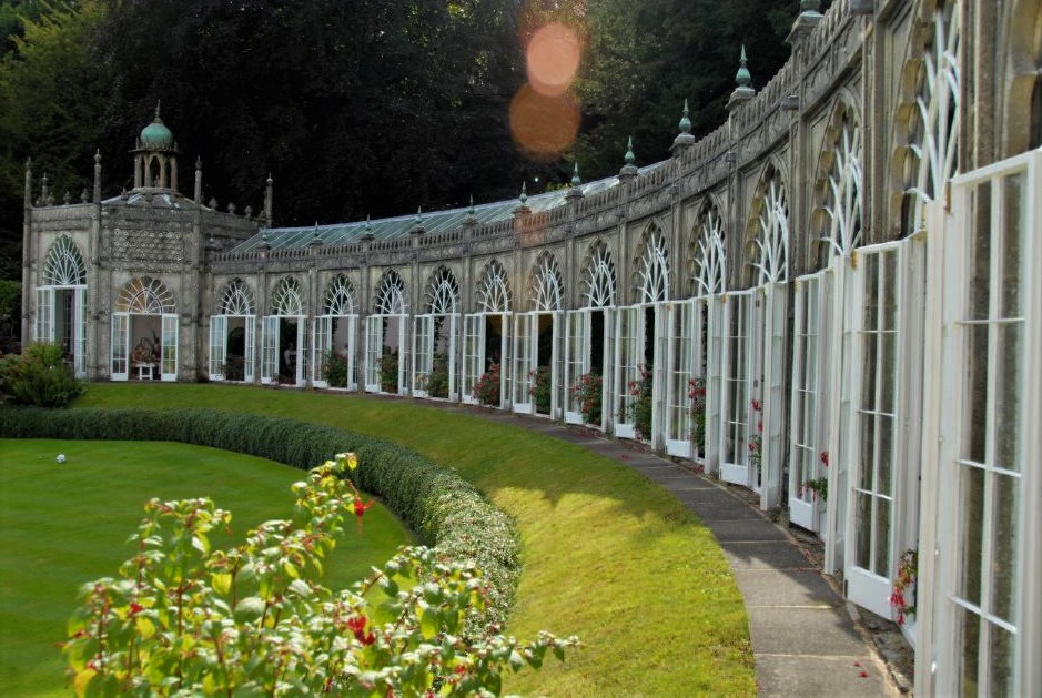 A curving wing of a mansion viewed from outside in the garden