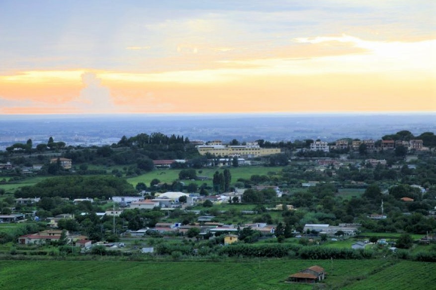 A valley of farmland at sunset