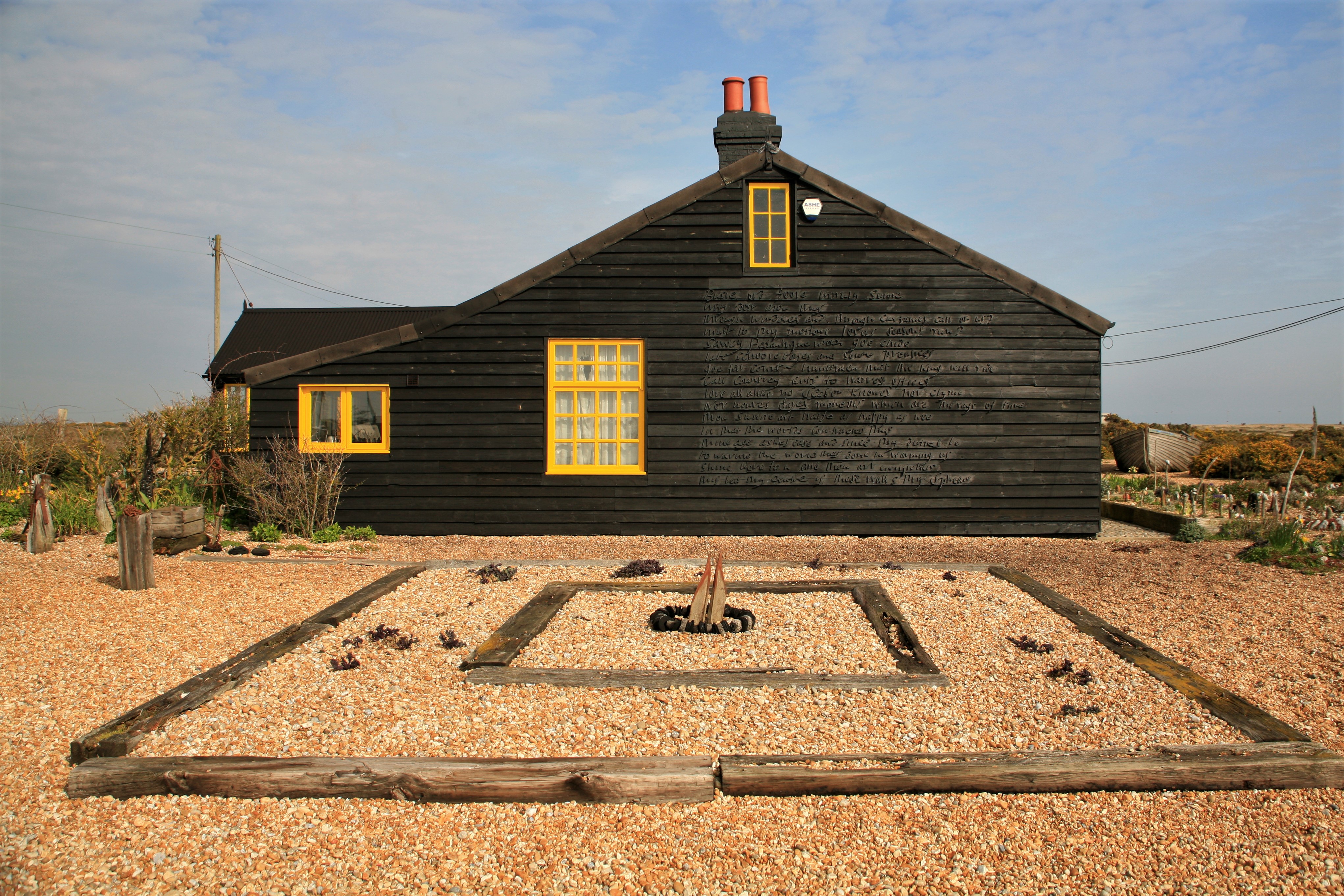 The gravel-covered back garden of a seaside cottage