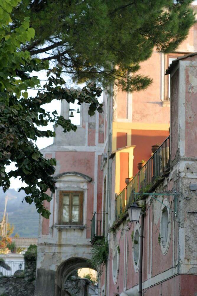 A row of salmon coloured stone buildings