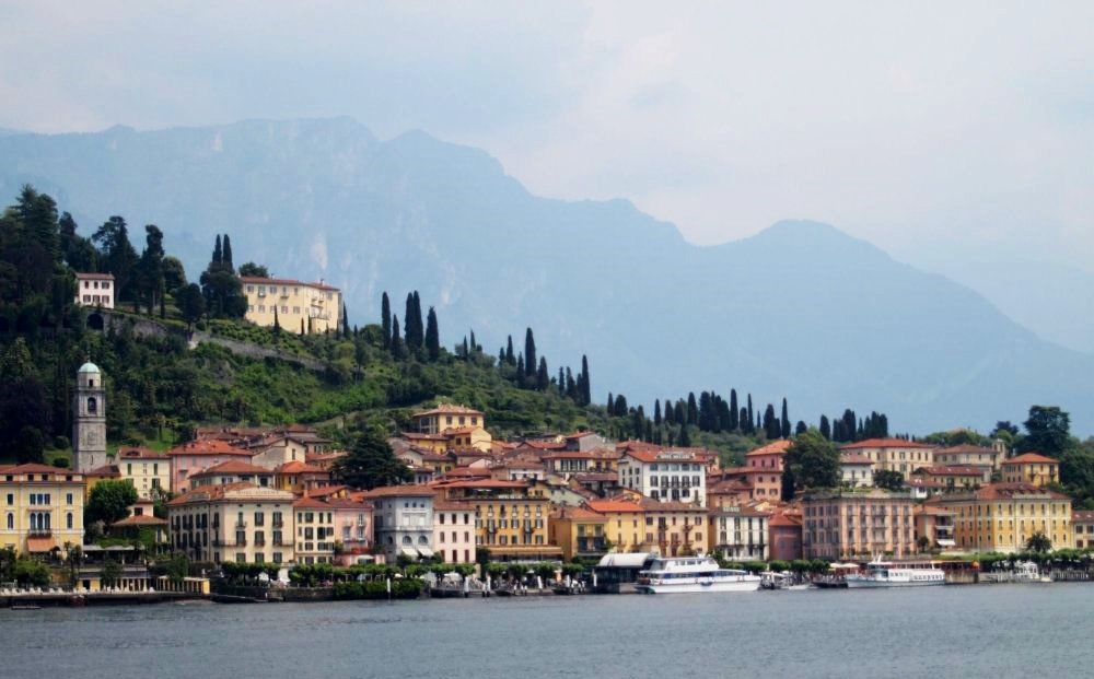 Houses lining the coast of Lake Como, viewed from the opposite coast