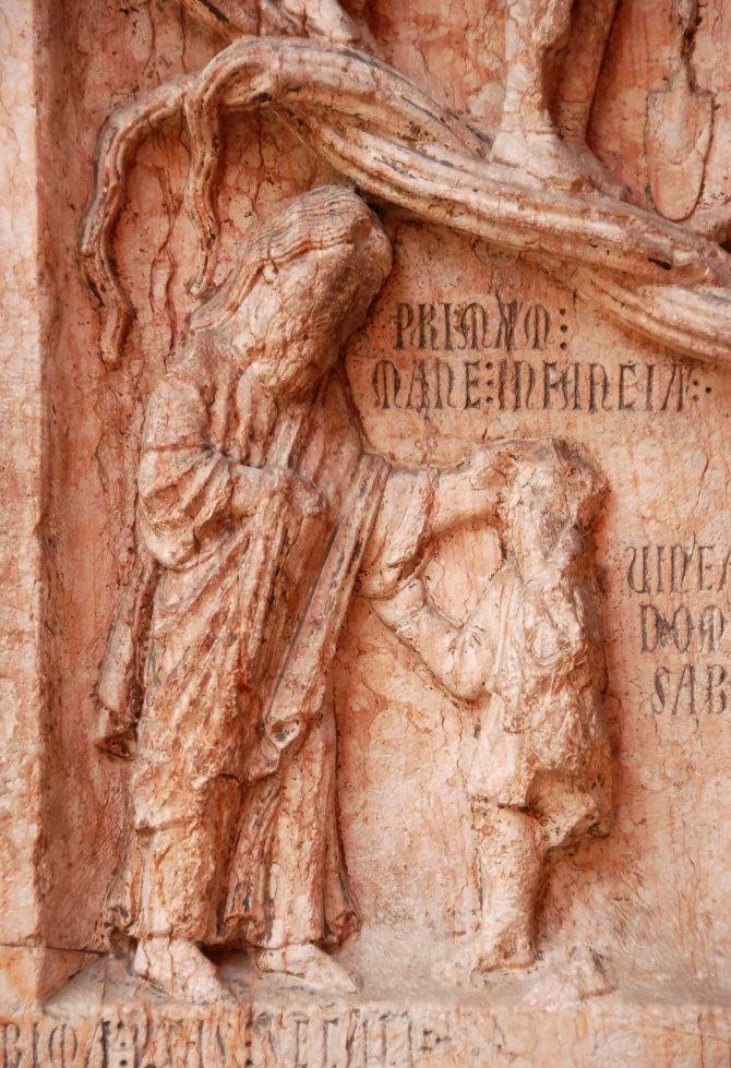 A stone frieze depicting an old man and a young boy