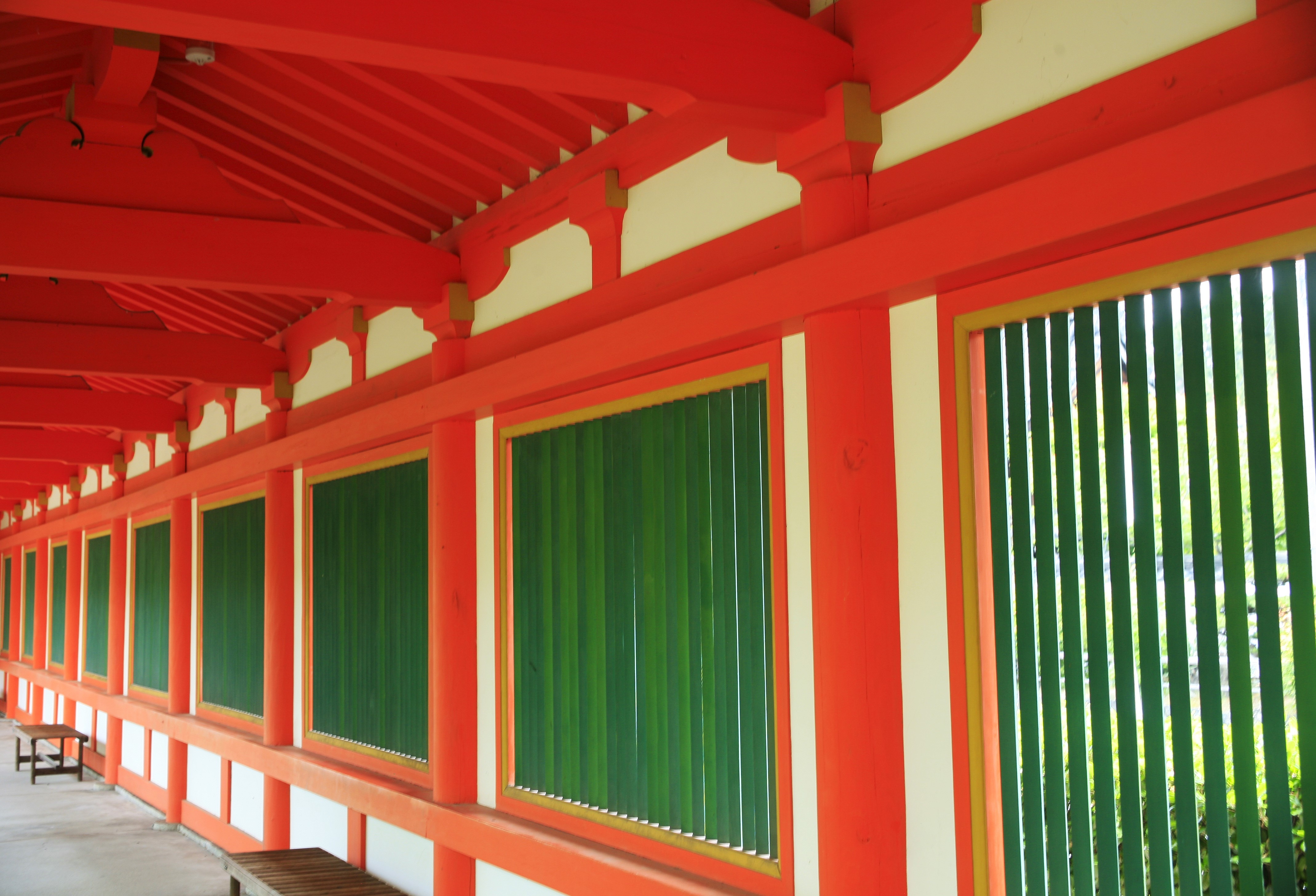 A corridor inside a pagoda with red columns