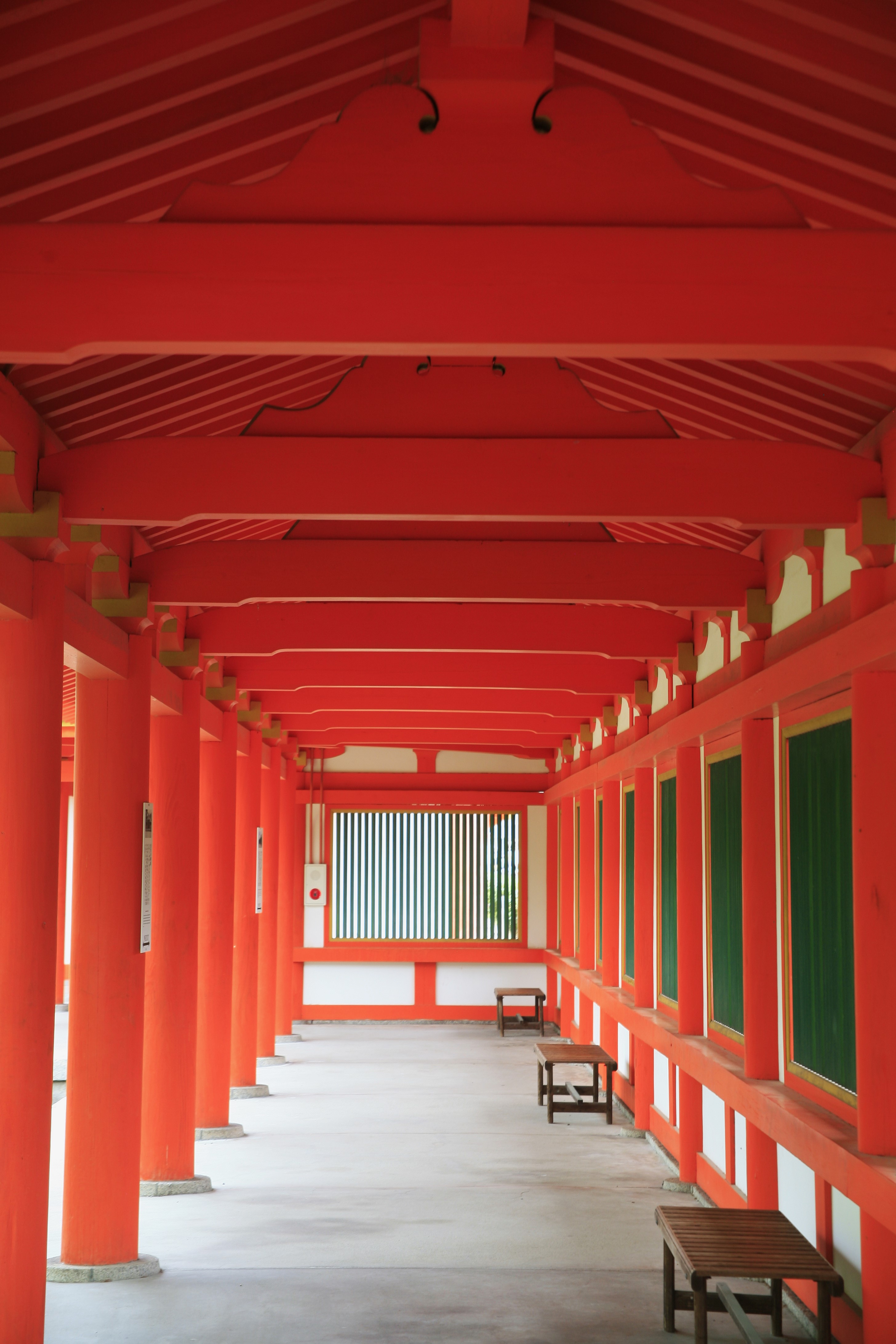 A corridor inside a pagoda with red columns and red eaves