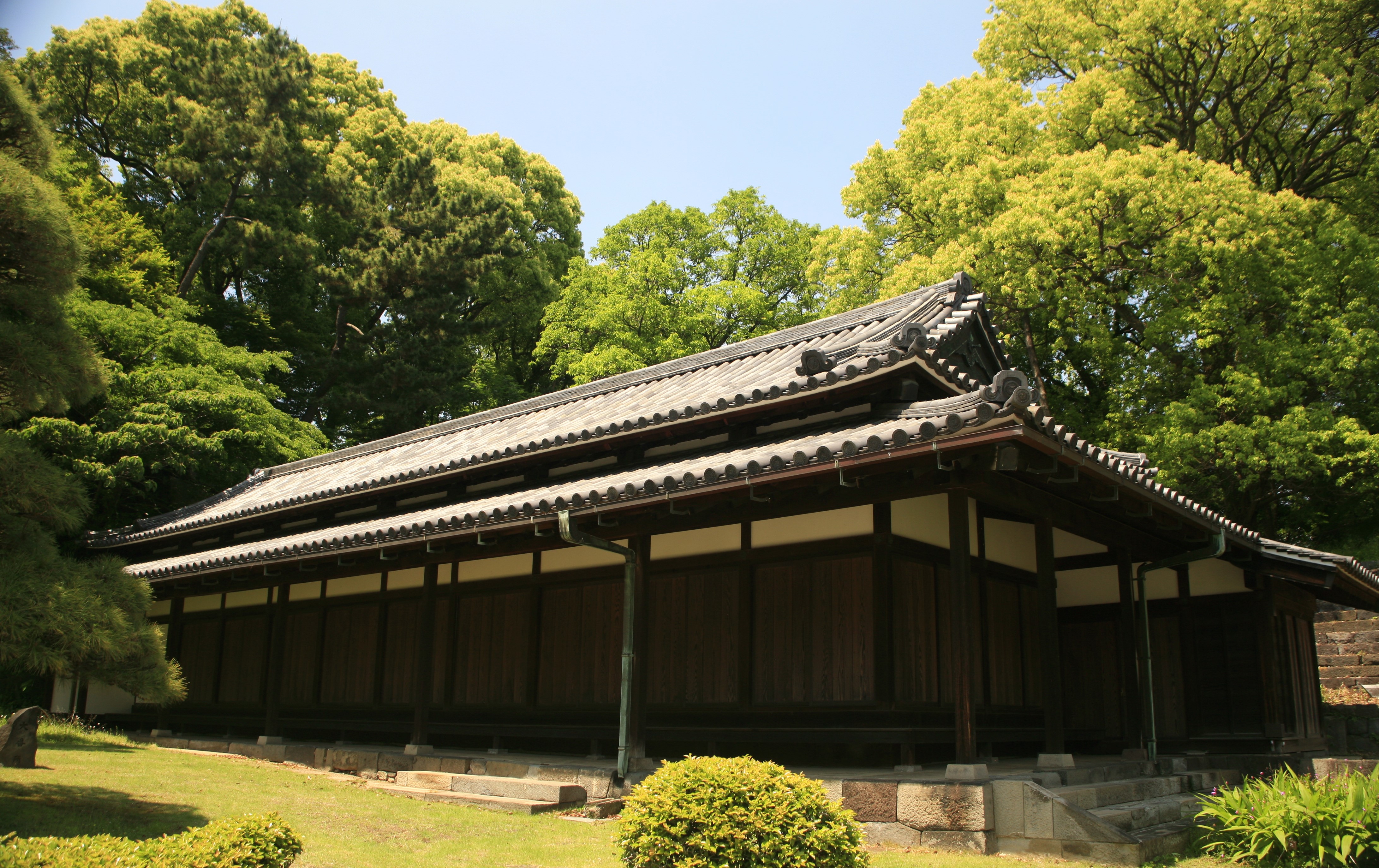 A wing of the Imperial palace sits surrounded by bright green vegetation