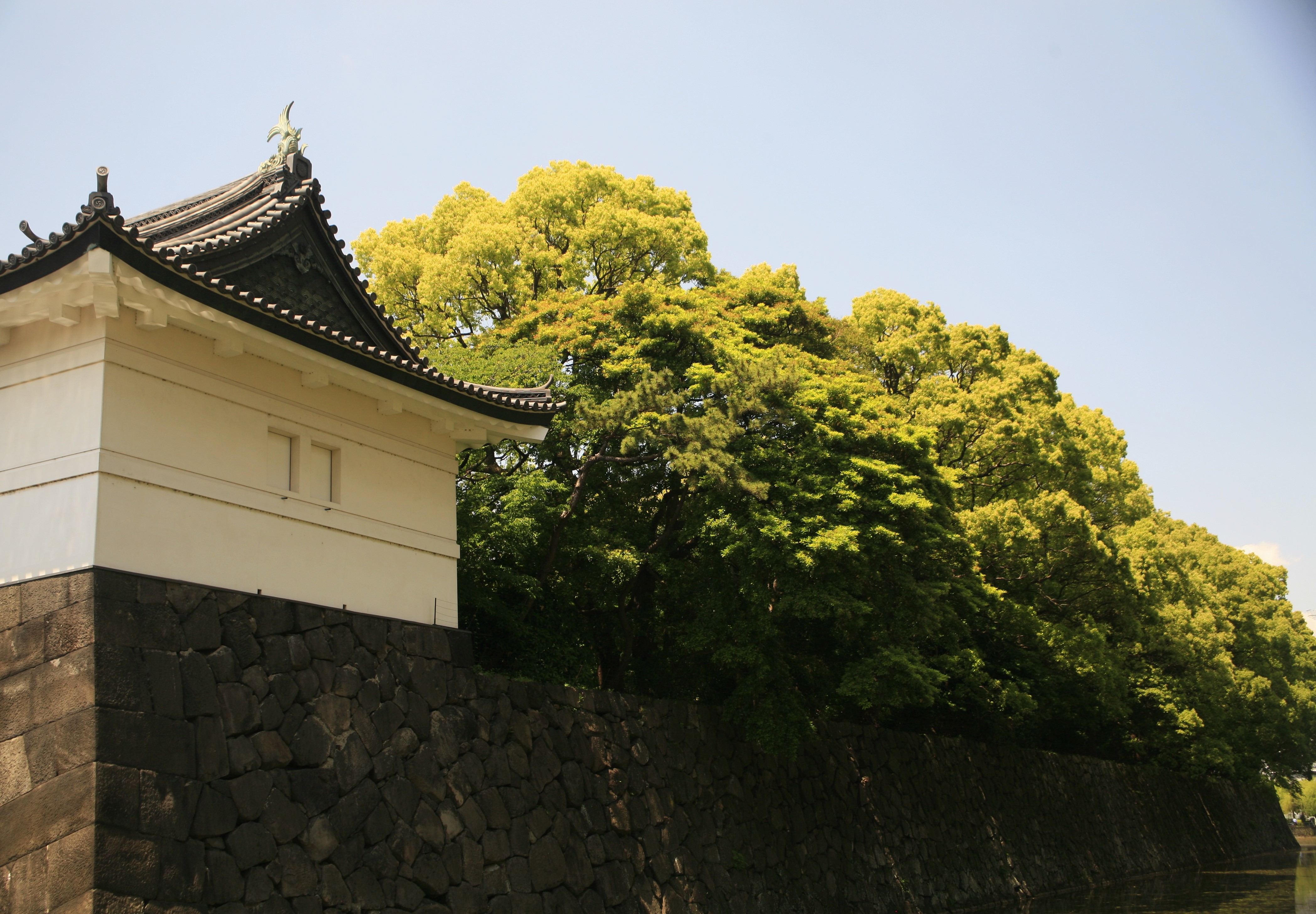 A tower of the Imperial Palace beside green trees